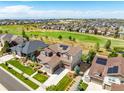 Aerial view of a house with solar panels, nestled in a community near a golf course at 7609 S Country Club Pkwy, Aurora, CO 80016