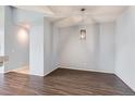 Neutral dining room with hardwood floors features a hanging light fixture and ample space at 14251 E 1St Dr # 305, Aurora, CO 80011