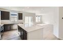 Bright, open kitchen featuring stainless appliances, a large island, and light wood floors at 10968 Snowdon St, Parker, CO 80134