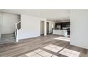 Spacious open floor plan with hardwood floors, stairs, and abundant natural light at 10968 Snowdon St, Parker, CO 80134