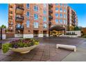 Beautiful brick apartment building with balconies and landscaped entrance at 2400 E Cherry Creek South Dr # 307, Denver, CO 80209