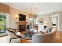 Cozy living room with fireplace, hardwood floors, and balcony access at 2400 E Cherry Creek South Dr # 307, Denver, CO 80209