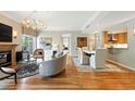 Open-concept living space with fireplace, dining area, and hardwood floors at 2400 E Cherry Creek South Dr # 307, Denver, CO 80209