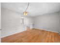 Bright dining room with hardwood floors and view into living room at 4795 S Yank Way, Morrison, CO 80465