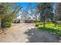 Attractive ranch home with attached garage, brick facade, and generous front yard with mature trees at 10490 W 78Th Ave, Arvada, CO 80005