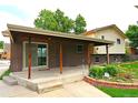 Charming covered back porch with brick accents and inviting outdoor space at 11823 Williams Way, Northglenn, CO 80233