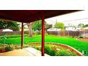 Lush backyard featuring a well-maintained lawn, mature trees, and inviting landscaping at 11823 Williams Way, Northglenn, CO 80233