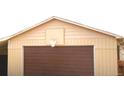 Garage with brown garage door and basketball hoop at 11823 Williams Way, Northglenn, CO 80233