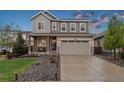 Charming two-story home with landscaped front yard, covered porch and attached two car garage at 16400 Alberta Dr, Parker, CO 80134