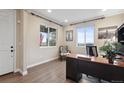 Bright office space featuring hardwood floors, natural light, and a modern desk setup at 16400 Alberta Dr, Parker, CO 80134