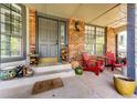 Inviting front porch with comfortable seating, brick columns, and charming decor creating a cozy outdoor space at 6762 Eagle Pl, Highlands Ranch, CO 80130