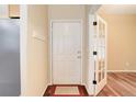 The foyer features hardwood floors, coat hooks, and a door with glass panels at 354 Willowick Cir, Highlands Ranch, CO 80129