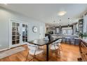 Dining Room features hardwood floors, elegant light fixture, and neutral color palette at 537 N 48Th Ave, Brighton, CO 80601