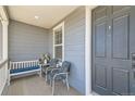 Charming covered porch with seating and stylish accents at 537 N 48Th Ave, Brighton, CO 80601