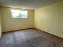 This bedroom offers natural light from a window overlooking outdoor greenery at 2325 S Linden Ct # 206, Denver, CO 80222