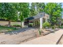 Exterior view of the building showcasing landscaped grounds, a covered entrance, and a welcoming driveway at 2325 S Linden Ct # 206, Denver, CO 80222