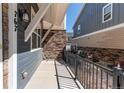 Charming front porch with a metal railing and partial view of the neighboring properties at 767 Robert St, Longmont, CO 80503