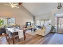 Bright living room with vaulted ceilings, hardwood floors, and a bay window offering lots of natural light at 15962 E Lehigh Cir, Aurora, CO 80013