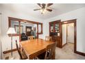 Traditional dining room featuring wood trim, classic built-in cabinet, and adjacent living area at 4536 Beach Ct, Denver, CO 80211
