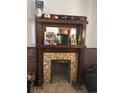 A wood fireplace with mantel that has various items on top at 4536 Beach Ct, Denver, CO 80211