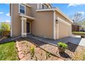 Two-story home features charming curb appeal with flower beds and lush green lawn at 21950 E Crestline Ln, Aurora, CO 80015
