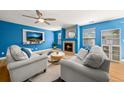 Living room with plush seating, a cozy fireplace, and plenty of natural light at 21950 E Crestline Ln, Aurora, CO 80015