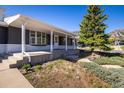 Eye-level view of the home's front exterior and front porch, featuring a professionally landscaped yard at 2610 Heidelberg Dr, Boulder, CO 80305