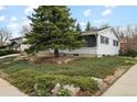 Charming single-story home with mature landscaping featuring a mature evergreen tree at 2610 Heidelberg Dr, Boulder, CO 80305