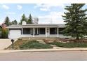 Inviting home exterior featuring a well-maintained front yard and a welcoming covered front porch at 2610 Heidelberg Dr, Boulder, CO 80305