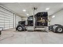 Spacious garage interior with a large black semi-truck inside at 7837 S Settlers Dr, Morrison, CO 80465