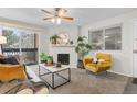 Bright living room featuring a fireplace, seating, a window, and sliding glass doors at 14652 E 2Nd Ave # 200D, Aurora, CO 80011
