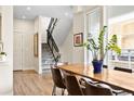 Bright dining area with modern wood table, seating, and staircase in an open concept space at 4537 N Tennyson St # 101, Denver, CO 80212