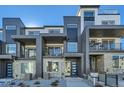 Contemporary townhome exterior with a mix of brick and siding, plus private balconies at 1759 Peak Loop, Broomfield, CO 80023