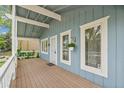 Inviting covered front porch with a light blue exterior, white trim, and lots of natural light at 280 Pierce St, Erie, CO 80516