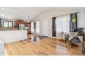 Open concept living room with hardwood floors and an open pass through to the kitchen at 280 Pierce St, Erie, CO 80516