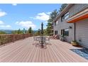 Large wooden deck with mountain views, outdoor seating, and a cozy lounge area, perfect for entertaining at 420 Chinook Rd, Idaho Springs, CO 80452