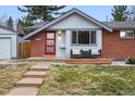 Charming home featuring a red front door and a cozy front porch with patio furniture at 2958 E Euclid Pl, Centennial, CO 80121