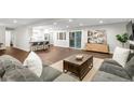 Open-concept living area featuring modern furnishings and an eat-in kitchen with barstool seating at 9861 E Ohio Ave, Denver, CO 80247