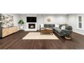 Cozy living room with a modern fireplace, mounted TV, and sleek hardwood floors at 9861 E Ohio Ave, Denver, CO 80247