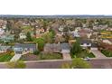 Expansive aerial view of a neighborhood showcasing various homes and lush green trees at 7282 S Vance St, Littleton, CO 80128
