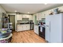 Bright kitchen with white cabinets, stainless steel appliances, hardwood floors, and generous counter space at 4665 E Peakview Ave, Centennial, CO 80121