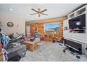Inviting living room featuring a cozy atmosphere, wooden decor, and natural light from the window at 6100 Bear Paw Rd, Golden, CO 80403