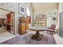 Sunlit dining room featuring floral wallpaper and hardwood furniture at 916 Griffith St, Georgetown, CO 80444