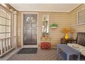 Inviting front porch with decorative plants and a comfortable seating area at 916 Griffith St, Georgetown, CO 80444