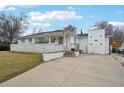 Charming home features a white exterior, concrete driveway, and fenced-in yard at 3075 S Emerson Way, Englewood, CO 80113