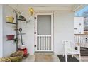Inviting front porch featuring the house number and a charming arrangement of decorative items and plants at 3075 S Emerson Way, Englewood, CO 80113