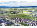 Wide aerial view showing the community's placement within the wider landscape, framed by distant mountains at 2936 Merry Rest Way, Castle Rock, CO 80109