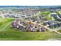 Aerial view showcases the neighborhood's location within a larger community, surrounded by green spaces at 2936 Merry Rest Way, Castle Rock, CO 80109