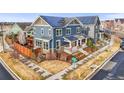A solar-paneled home with a fenced yard and nearby street access at 7903 E 50Th Dr, Denver, CO 80238