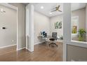 Bright office space with hardwood floors and a modern ceiling fan at 7903 E 50Th Dr, Denver, CO 80238